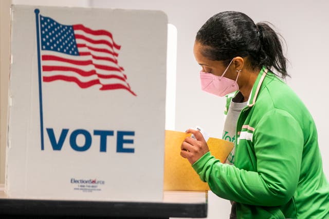 <p>A voter fills out her ballot at the Fairfax County Government Center polling location in Fairfax, Virginia on Tuesday </p>