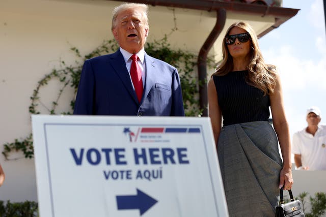 <p>Former U.S. President Donald Trump stands with former first lady Melania Trump as he speaks to the media after voting at a polling station</p>