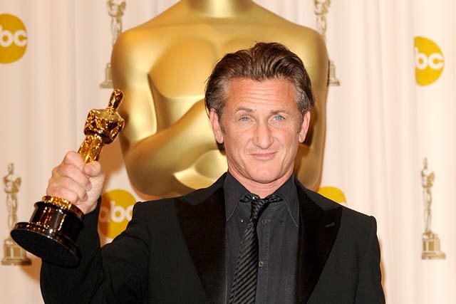 Sean Penn gives one of his Oscars to Ukrainian president Volodymyr Zelensky (Ian West/PA)