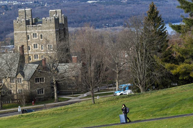 <p>A Cornell University student walks along the campus in Ithaca, N.Y., on Dec. 16, 2021</p>