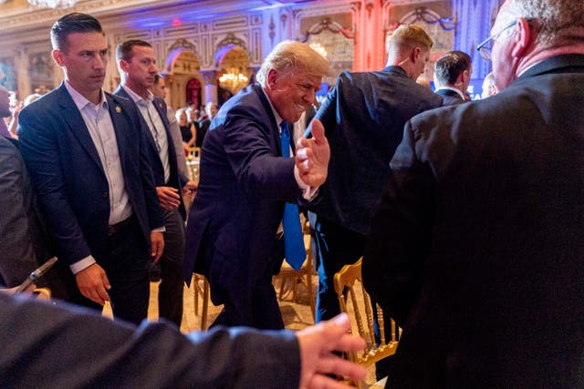 <p>Former President Donald Trump greats guests at Mar-a-lago on the day of the 2022 midterm elections</p>