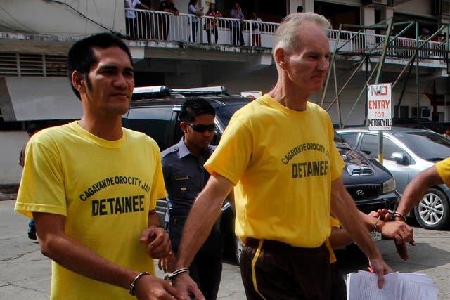 <p>File. Peter Scully  of Australia (R), accused of raping and trafficking two girls in the Philippines, leaves the court handcuffed to another inmate (L) after his arraignment in Cagayan de Oro City, on the southern Philippine island of Mindanao on June 16, 2015</p>