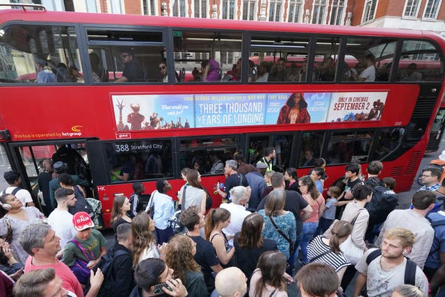 People getting on buses outside Liverpool St station in central London during the last Tube strike in August (Yui Mok/PA)