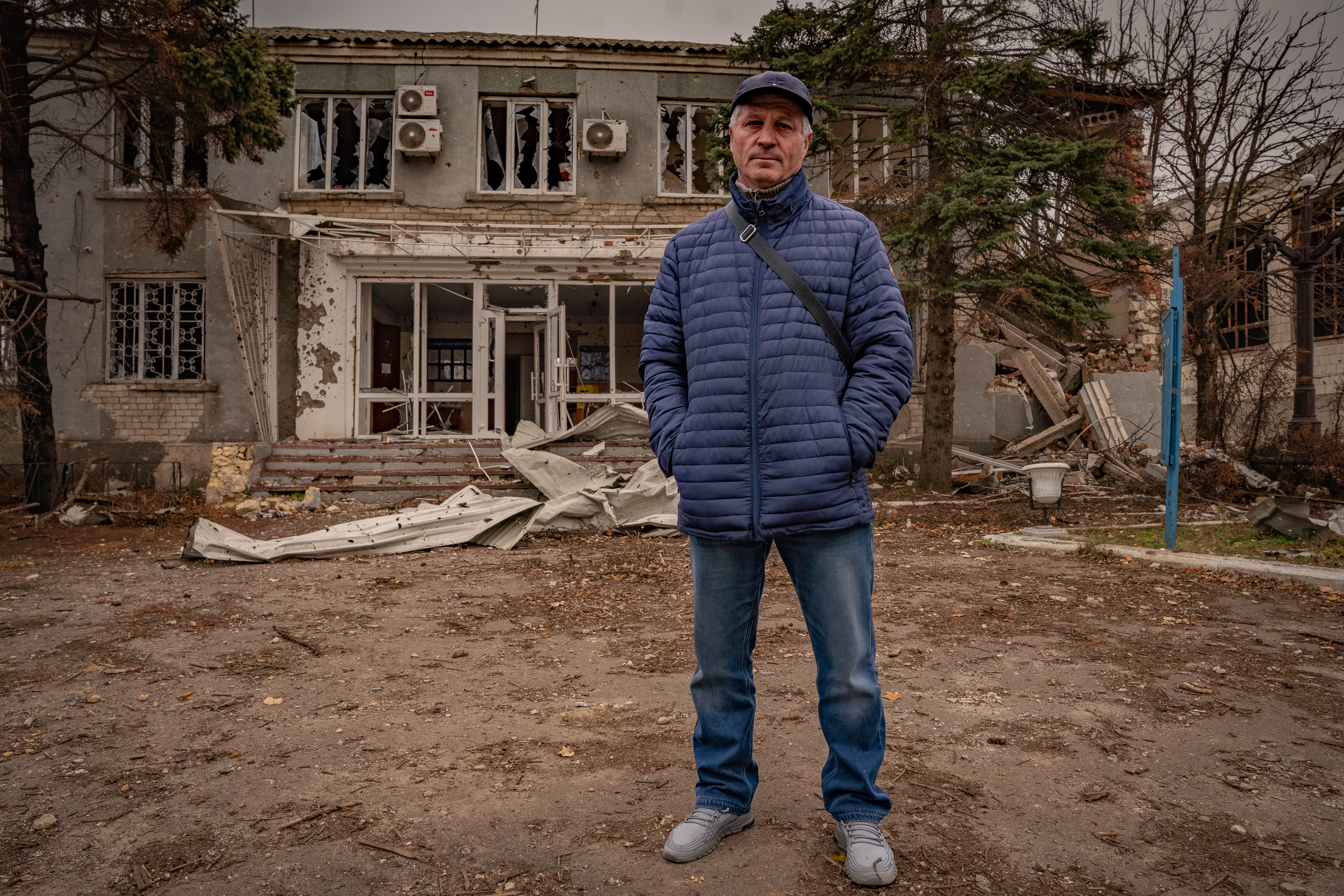The mayor of Osokorivka stands outside the destroyed remains of his offices