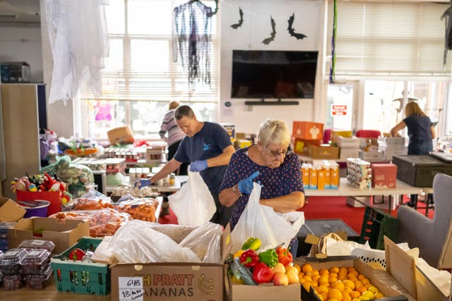 <p>Volunteers sort food into food parcels at the Rumney Forum community charity on November 8, 2022 in Cardiff</p>