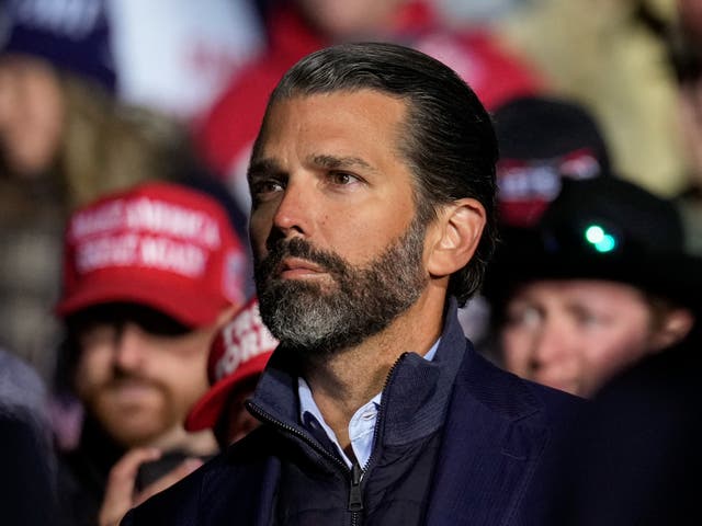 <p>Donald Trump Jr. listens as former President Donald Trump speaks at a rally at the Dayton International Airport on November 7, 2022 in Vandalia, Ohio</p>