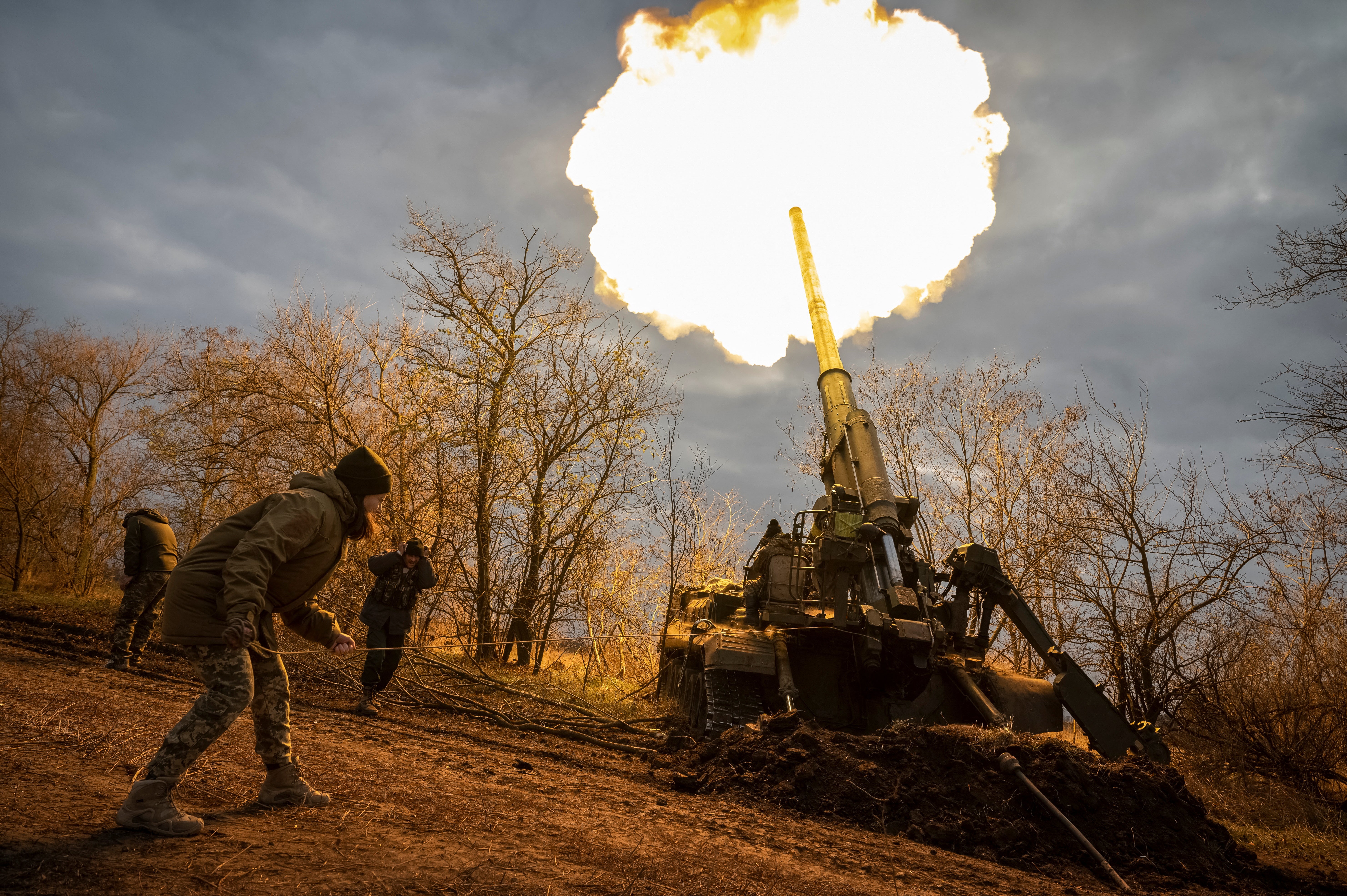 Ukrainian servicemen fire a self-propelled gun at a position on a frontline in the Kherson region