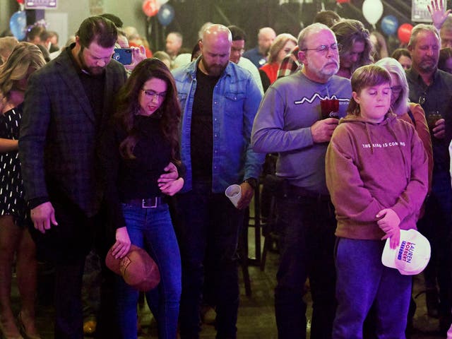 <p>Jayson Boebert puts his arms around his wife, Republican Congresswoman Lauren Boebert, as they pray during an election night party in Grand Junction, Colorado on Tuesday </p>