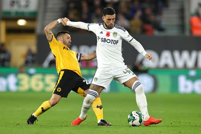 <p>Sam Greenwood of Leeds United is challenged by Joao Moutinho</p>