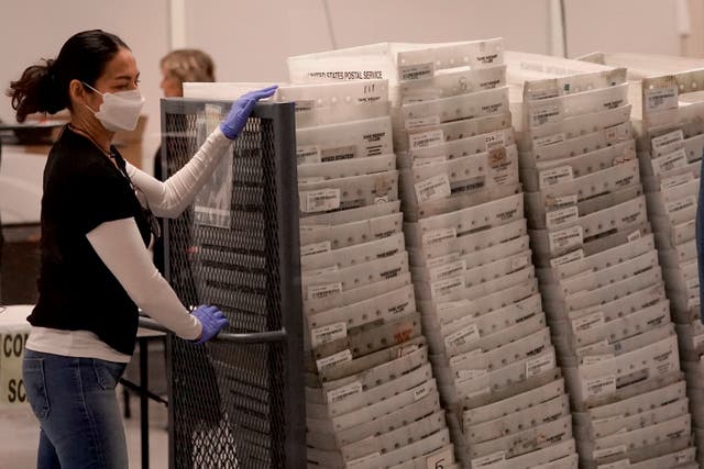 <p>An election worker arrives with ballot papers to be tabulated in Maricopa County </p>