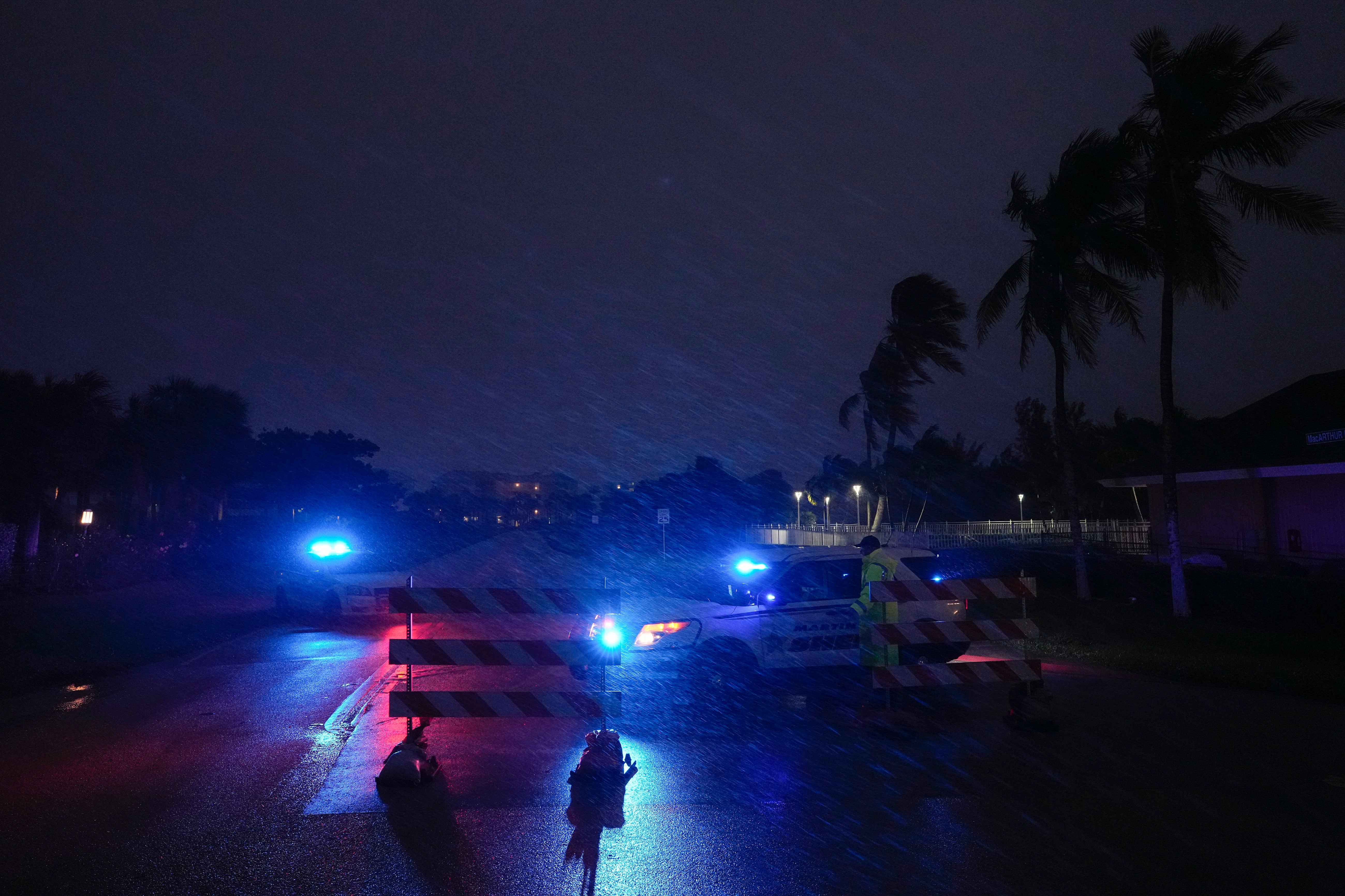 Police block off MacArthur Boulevard on Hutchinson Island as conditions deteriorate