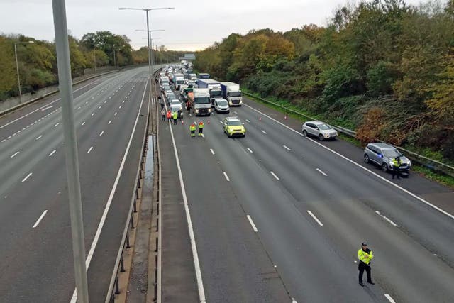 The M25 has been closed by police due to ongoing protests (Just Stop Oil/PA)