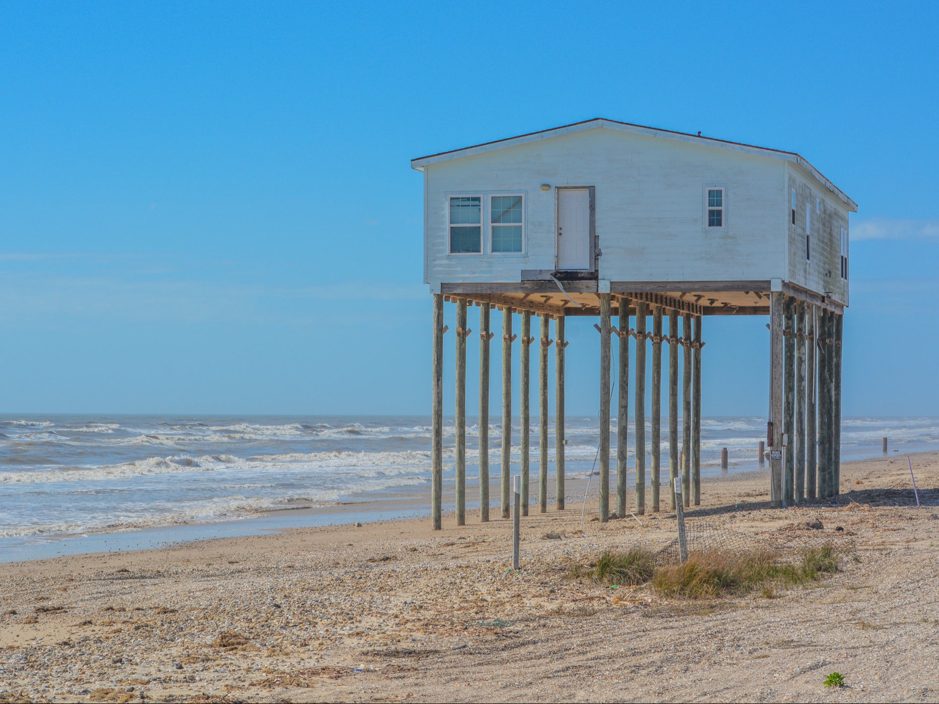 An abandoned house on a Texas beach in the Gulf of Mexico. We can only adapt to the climate crisis up to a point, so we must take action to limit the damage, scientists warn