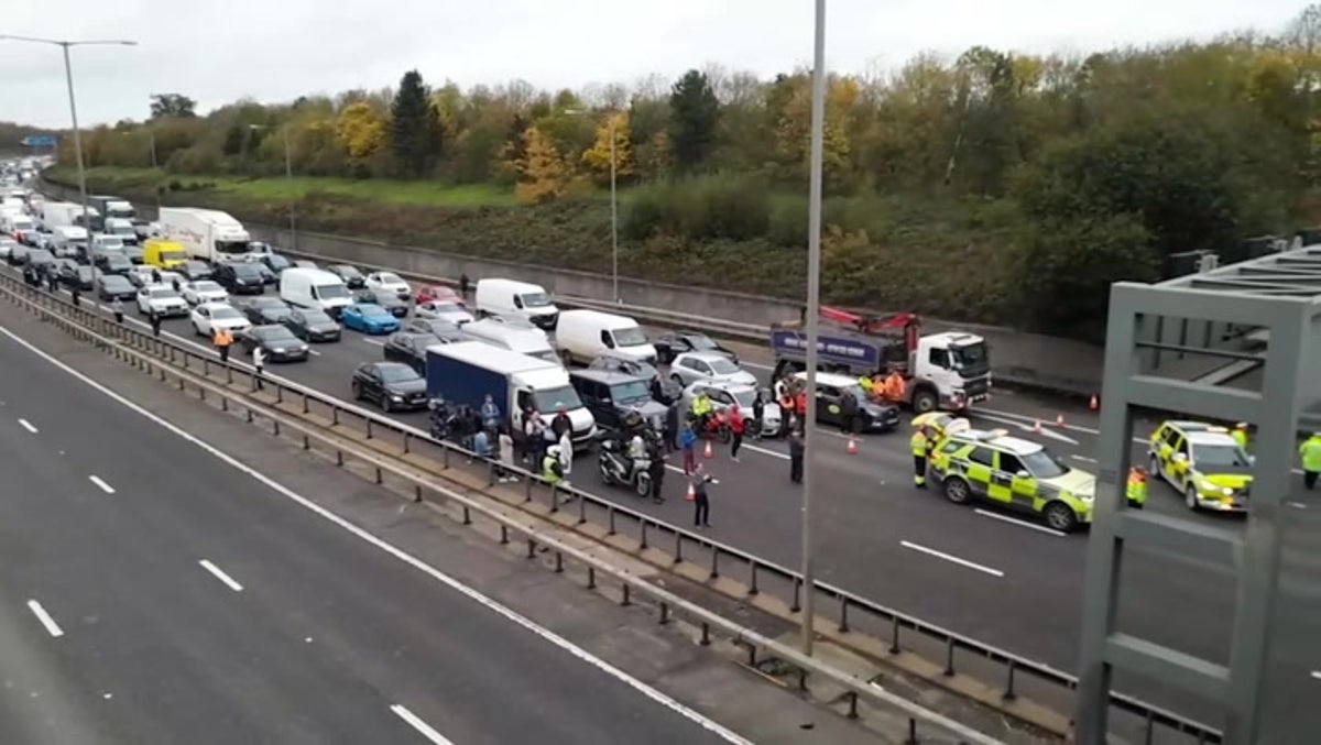Just Stop Oil: Drivers get out of vehicles in standstill M25 traffic near Heathrow