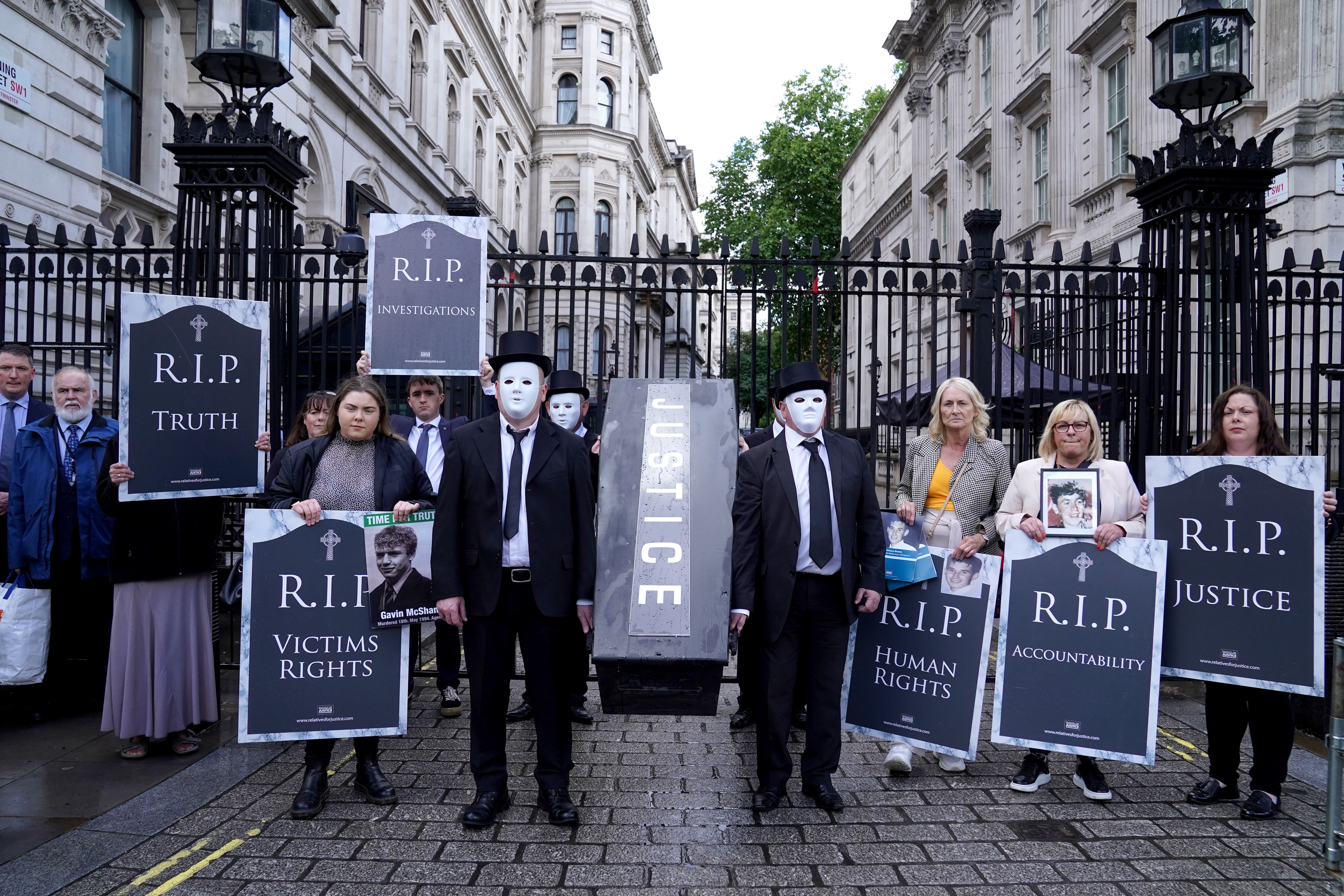 Representatives from Relatives for Justice, whose loved ones were murdered during the Troubles, protest outside Downing Street (PA)