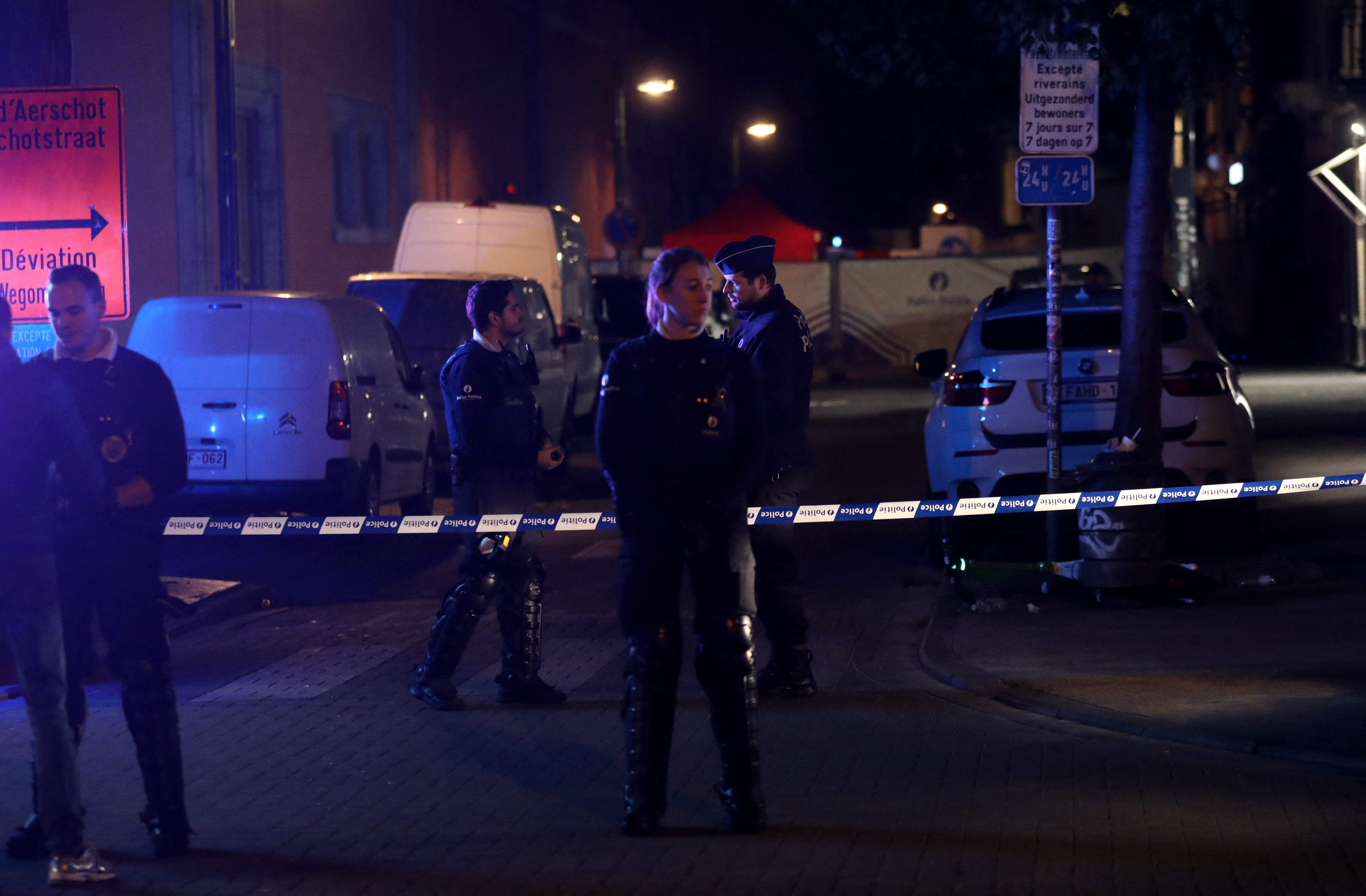 Police officers stand guard at the scene of a stabbing attack