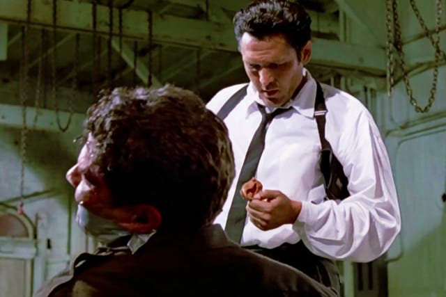 <p>Michael Madsen as Mr Blonde in Quentin Tarantino’s ‘Reservoir Dogs’ in 1992 – he slices off a cop’s ear</p>