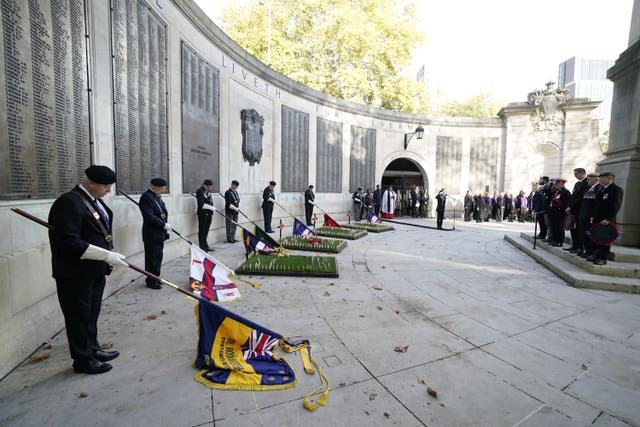 Flag bearers, veterans and members of the public observe a two-minute silence on Armistice Day (Andrew Matthews/PA)