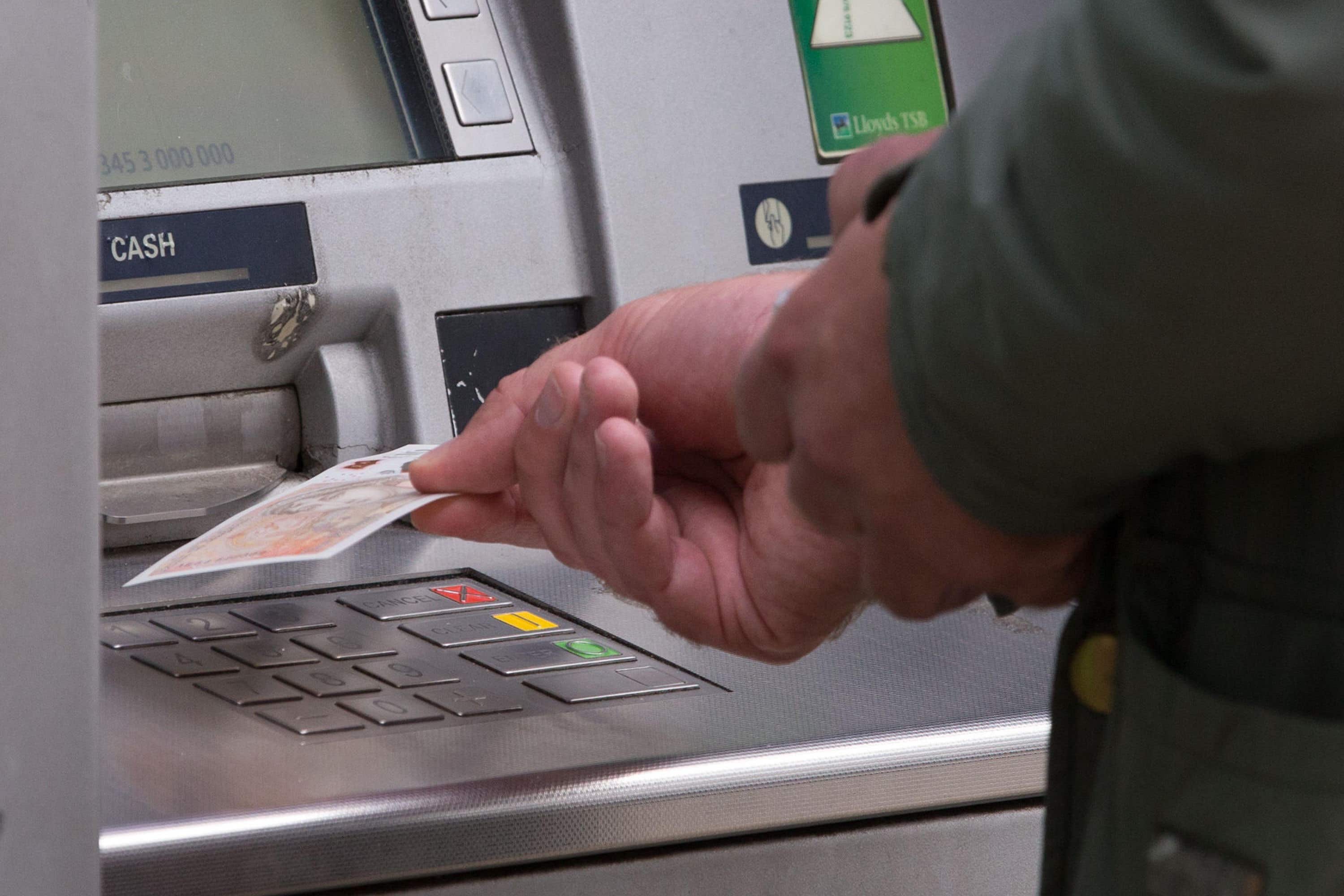 Cash machine use jumped this week as some cost-of-living payments started to hit bank accounts, according to ATM network Link (Aaron Chown/PA)
