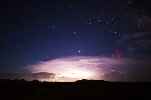 <p>Sprite lightning, the reddish streaks on the right, as seen over a thunderstorm in Arizona. The phenomenon was seen this week around the outer edges of Tropical Storm Nicole </p>