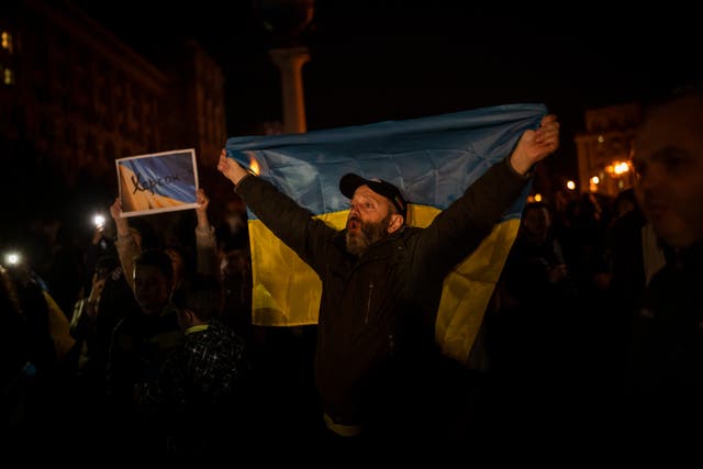 Ukrainians gather in central Kyiv to celebrate Russia’s departure from Kherson (Bernat Armangue/AP)