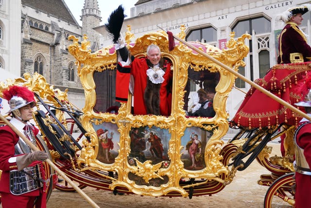 The new Lord Mayor of London Nicholas Lyons waves from his state coach at Guildhall (Jonathan Brady/PA)