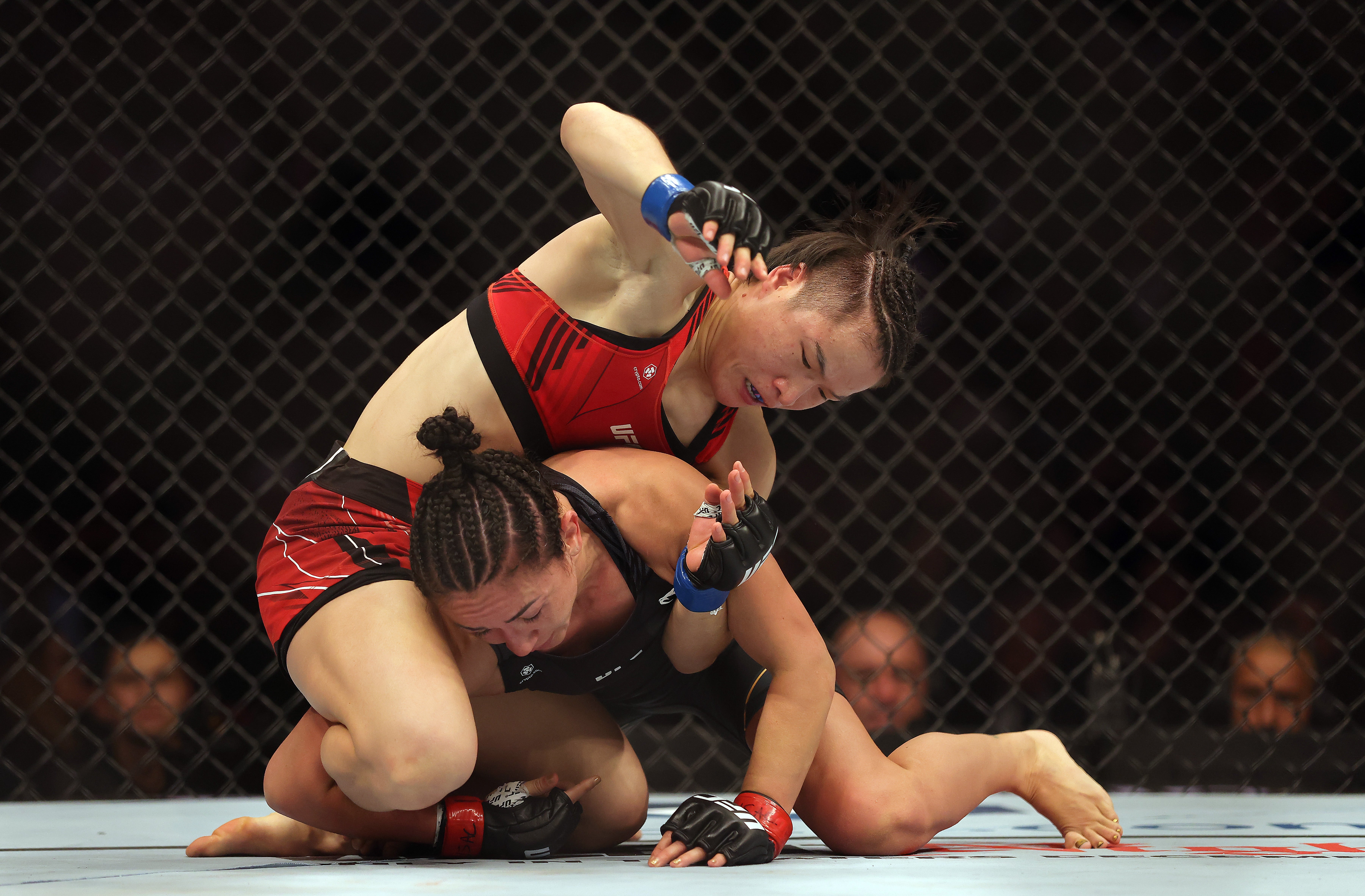 Zhang Weili (top) regained the strawweight title by submitting Carla Esparza