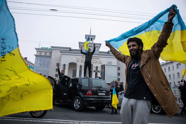 Ukrainians celebrate the recapturing of their city, Kherson (Yevhenii Zavhorodnii/AP)