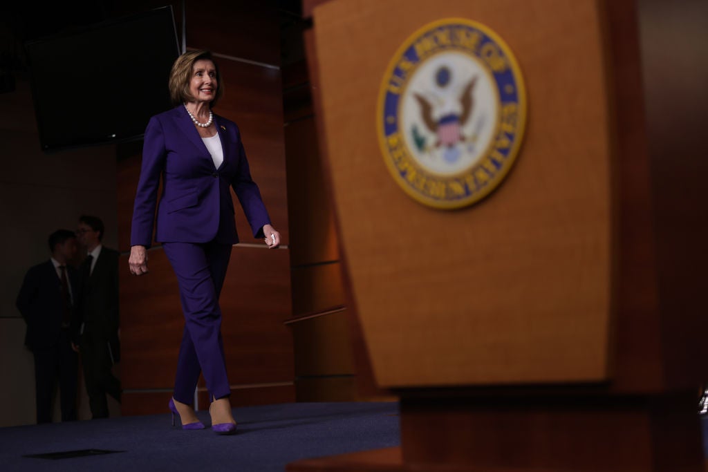 <p>Nancy Pelosi, Speaker of the US House of Representatives, walks towards the podium at her weekly press conference</p>