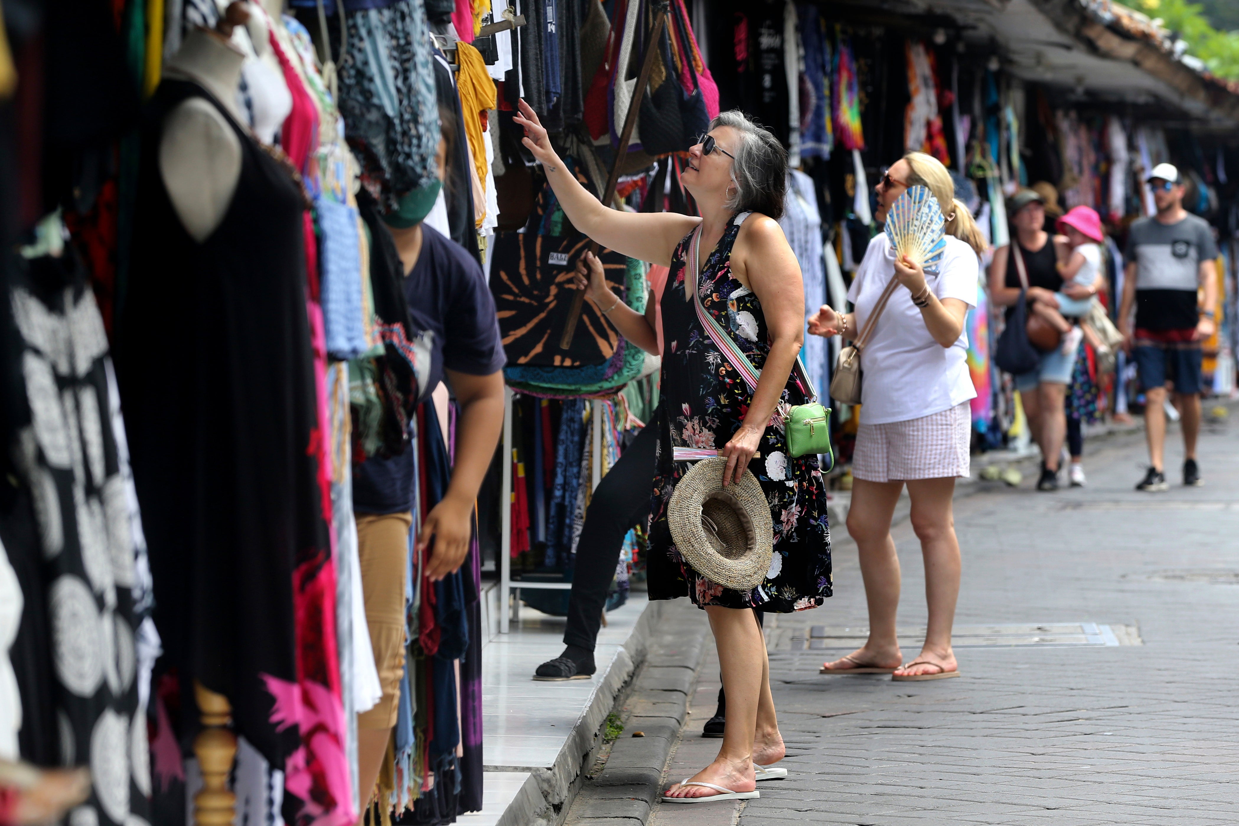 Foreign tourists shop for souvenirs in Bali, Indonesia