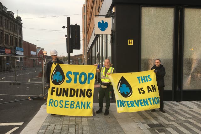 Protesters outside a branch of Barclays in Glasgow after its windows were broken (Extinction Rebellion/PA)