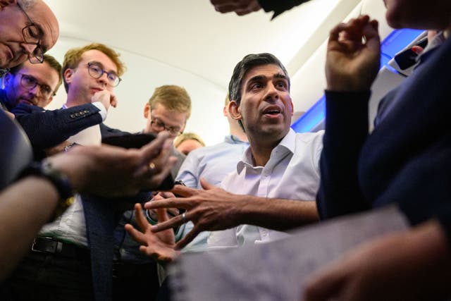 <p>Prime Minister Rishi Sunak holds a ‘huddle’ press conference with political journalists on board a Government plane as he heads to Bali to attend the G20 summit (Leon Neal/PA)</p>