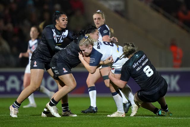 England’s Grace Field (centre) is tackled by New Zealand’s Mya Hill-Moana (Tim Goode/PA).