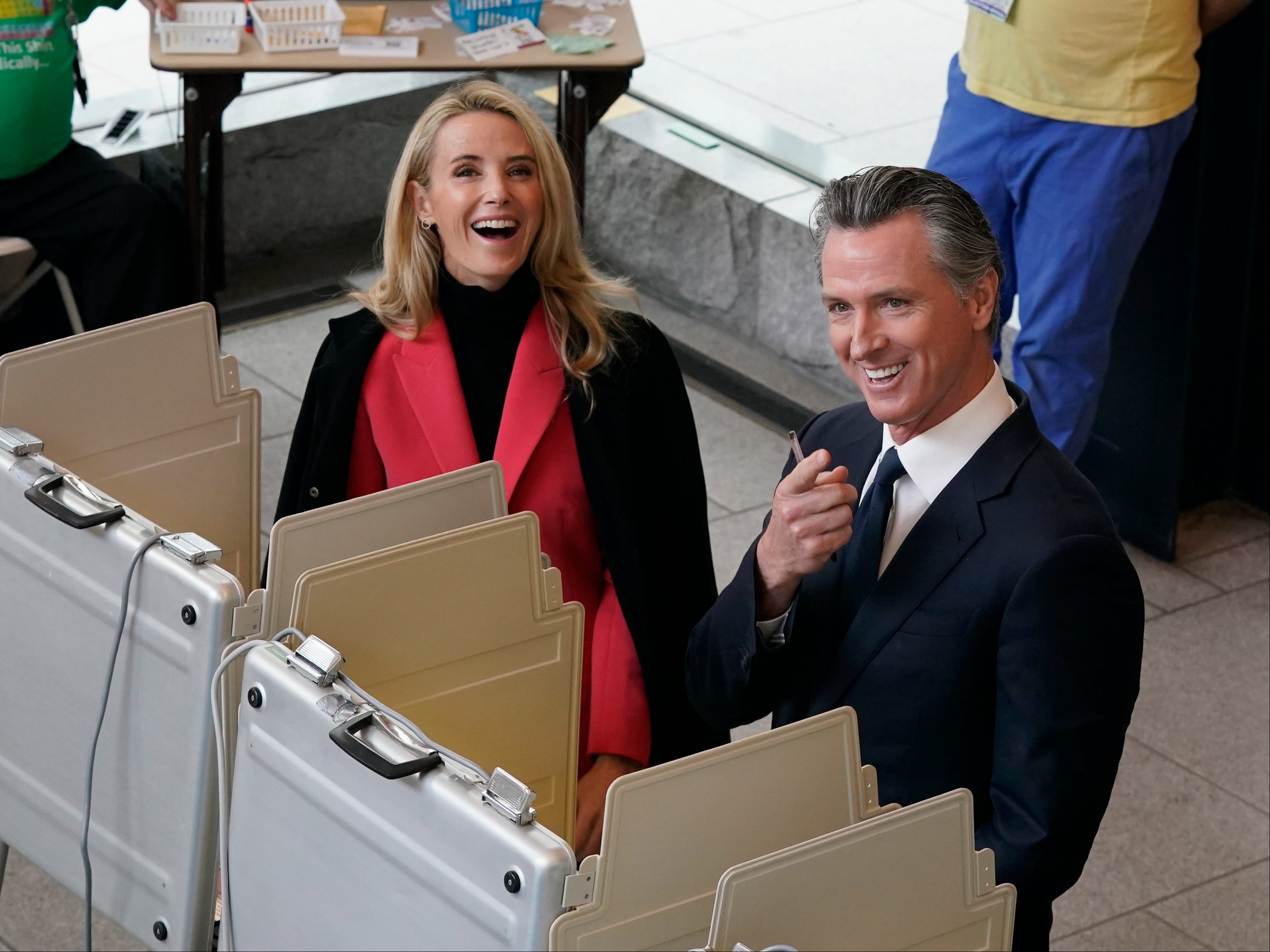 Jennifer Siebel Newsom and her husband Gavin Newsom pause as they spot photographers while voting in Sacramento on 8 November 2022