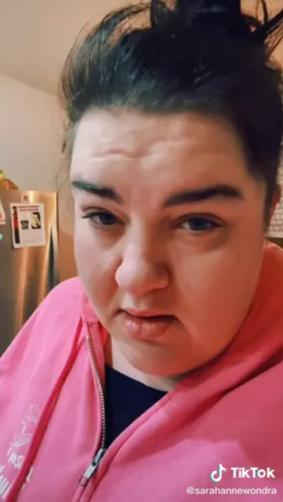 Sarah Wondra is seen in a resurfaced TikTok video with Michael Vaughan’s missing persons poster behind her, according to Fox News