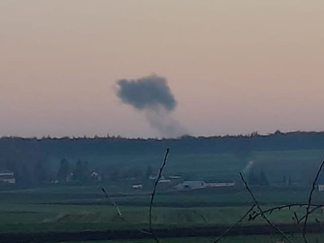 <p>Smoke rises in the distance, amid reports of two explosions, seen from Nowosiolki, Poland, near the border with Ukraine</p>