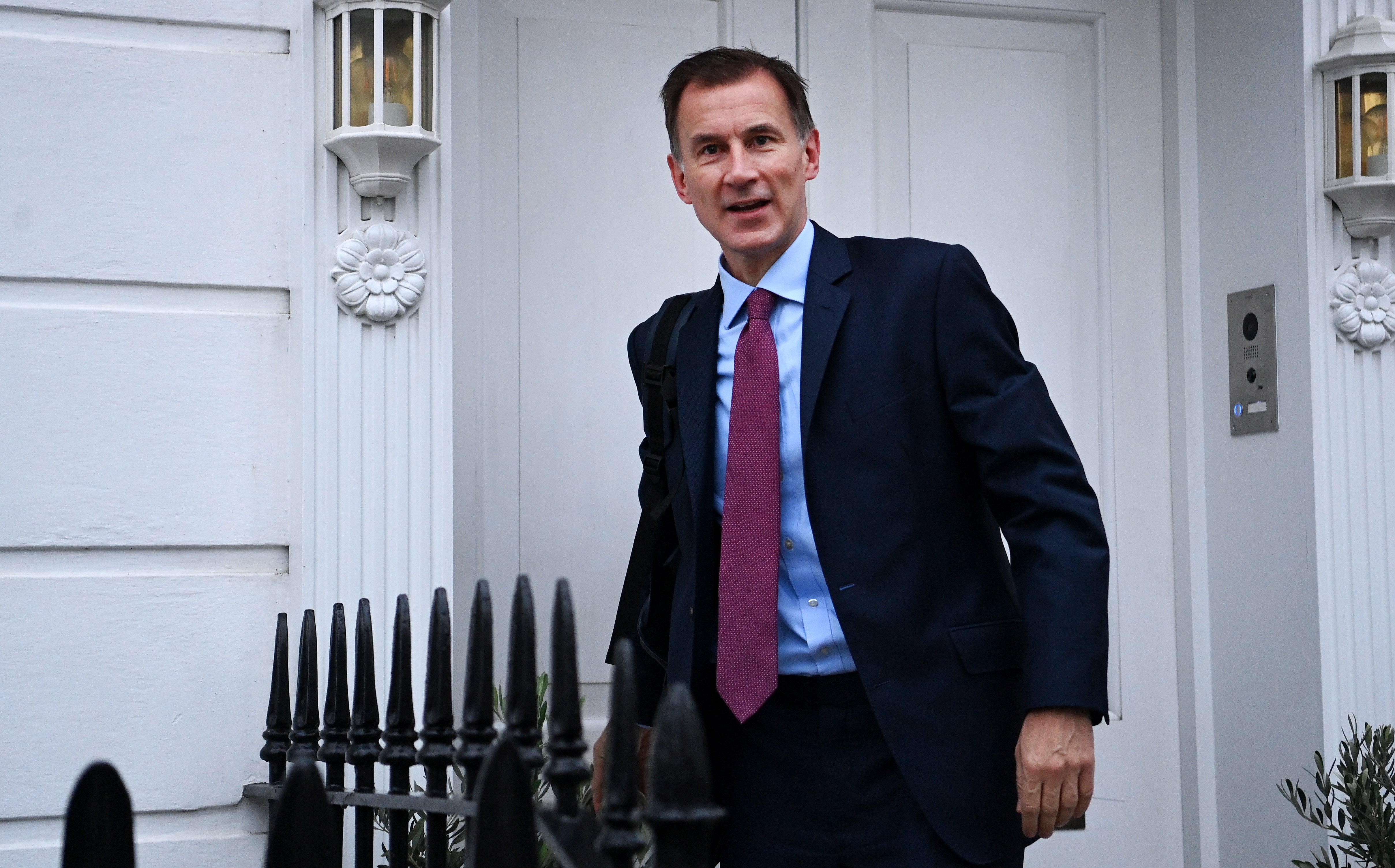 Hunt leaving his home in London on Wednesday morning as the inflation figures were released
