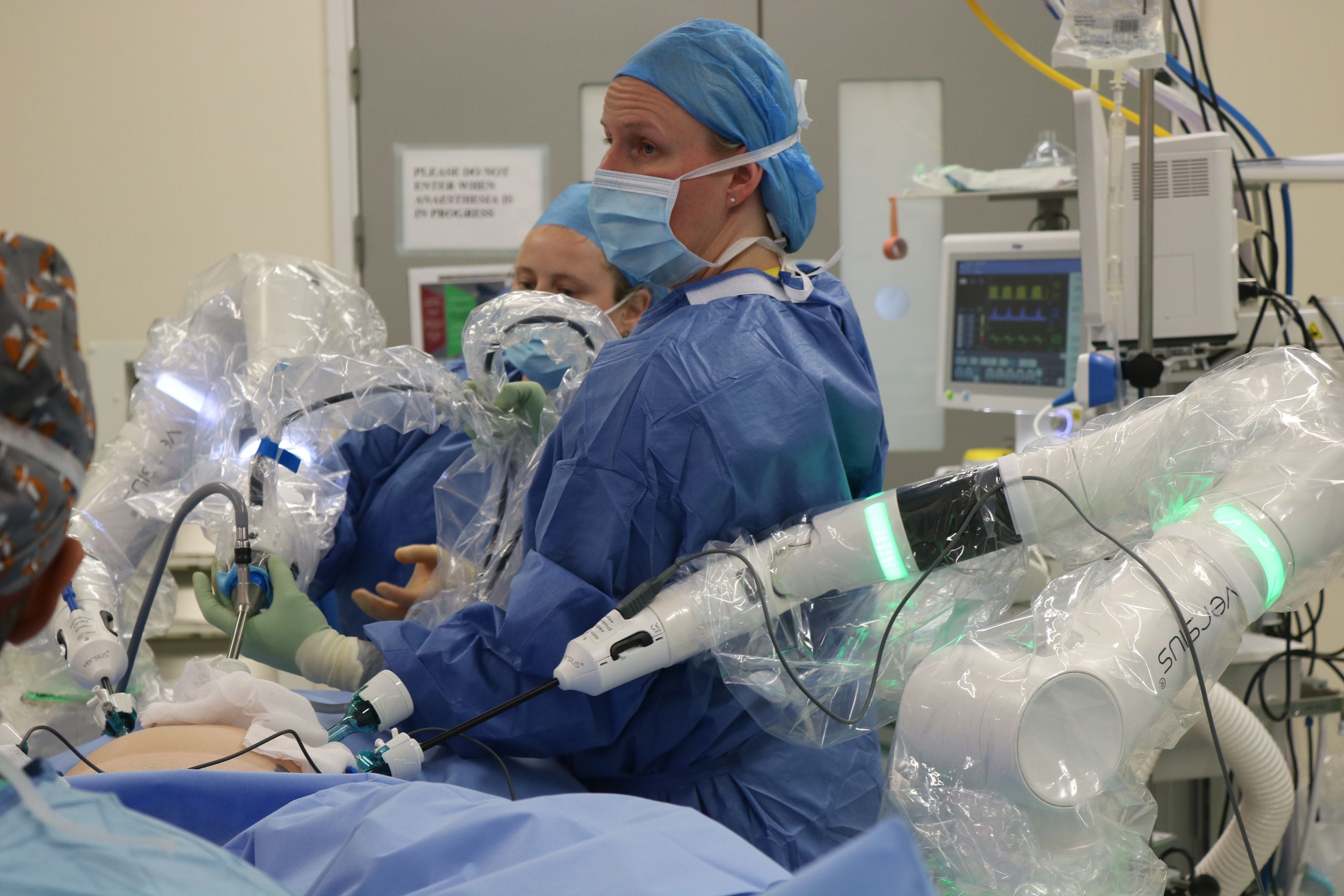 Betsi Cadwaladr University Health Board, Surgeon Miss Ros Jones ensuring the robotic arms are securely in place before she begins the first robotic hysterectomy in Wales (All-Wales National Robotics Assisted Surgery Programme).