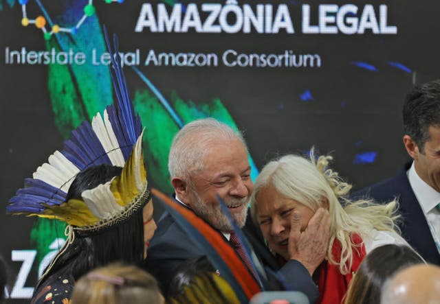 <p>Brazilian president-elect Luiz Inacio Lula da Silva (C) hugs singer Fafa de Belem (R) during a discussion about the Amazon rainforest at Cop27 in Egypt</p>