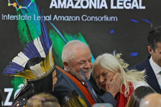 <p>Brazilian president-elect Luiz Inacio Lula da Silva (C) hugs singer Fafa de Belem (R) during a discussion about the Amazon rainforest at Cop27 in Egypt</p>
