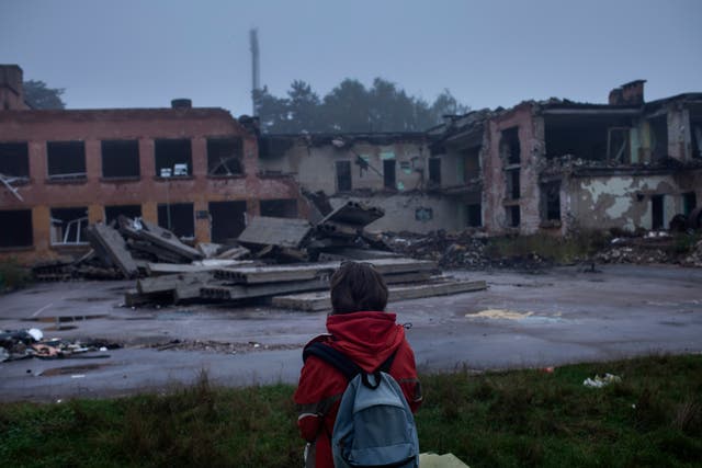 <p>Darya Nikolayenko, 14, sits looking at his destroyed school in Chernihiv</p>