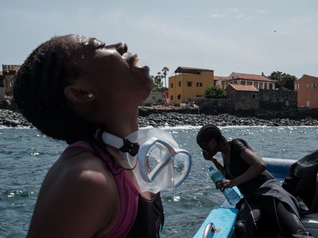<p>Grace Grodje, a doctoral student in maritime archaeology, gargles to clear her mouth after a morning dive</p>