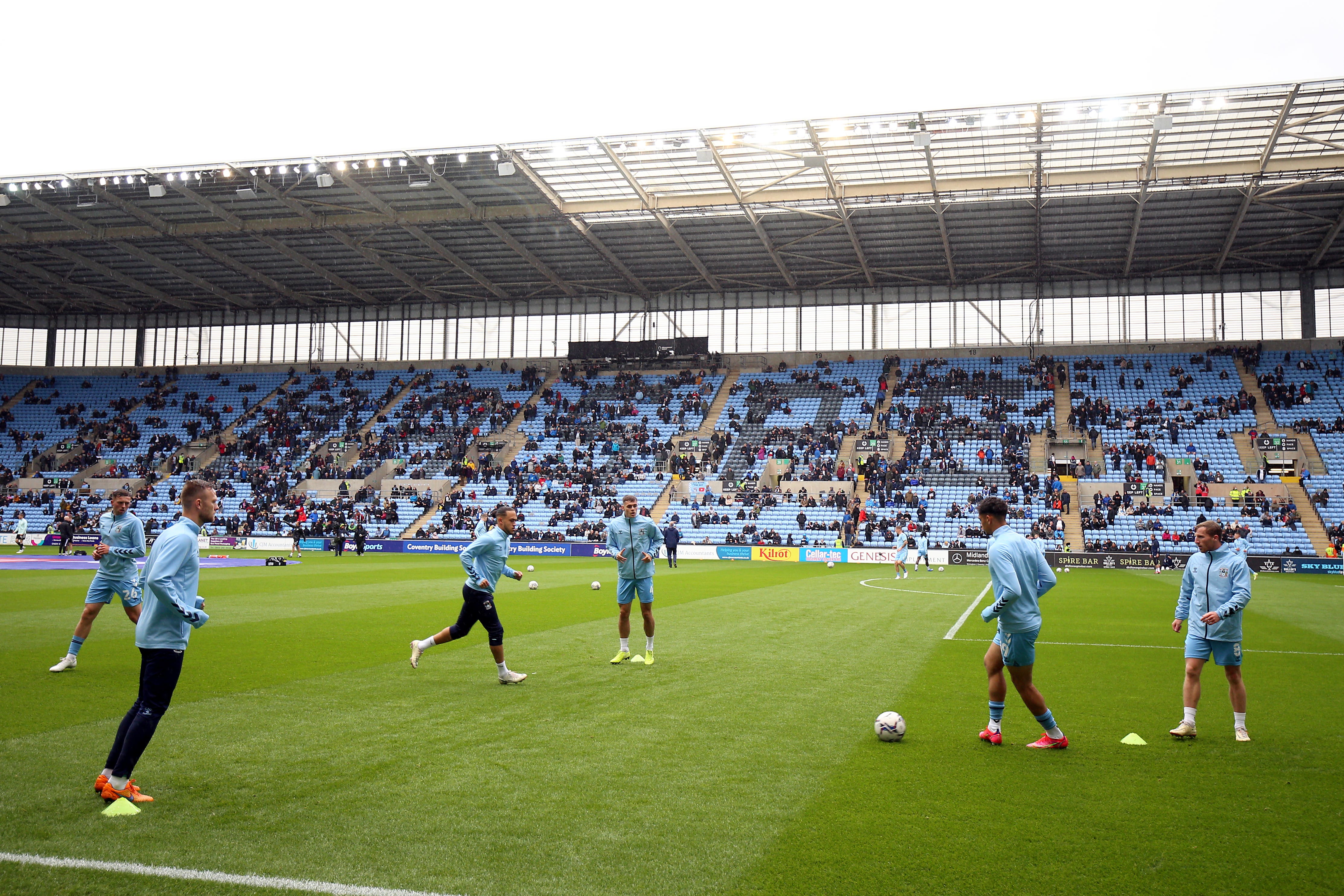 Coventry City players warm up on the pitch before the Sky Bet Championship match at the Coventry Building Society Arena in October 2021 (PA)