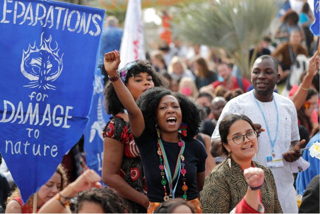 <p>Climate activists protest outside the Sharm el-Sheikh International Convention Centre in the final days of the Cop27 climate conference </p>