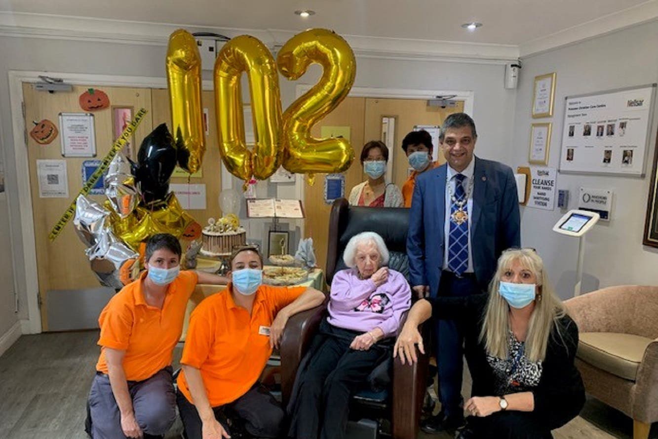 Joyce Tofts (wearinga purple jumper) alongside the Mayor of Woking and several carers at Princess Christian Care Centre (Princess Christian Care Centre/PA)