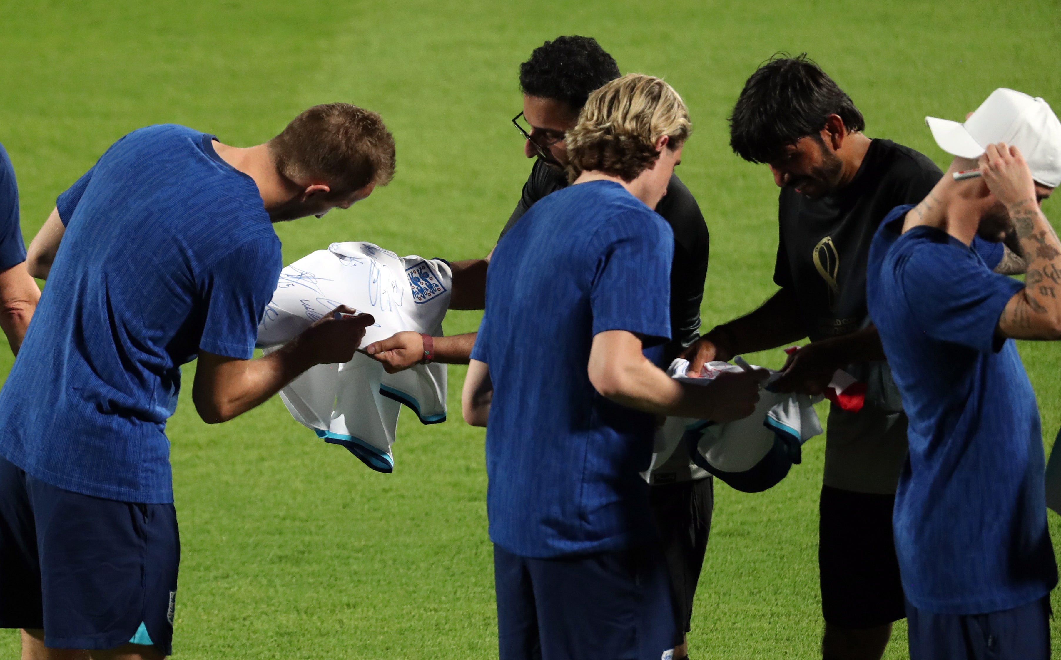 The team, including captain Harry Kane, signed shirts