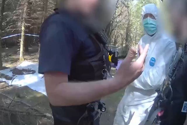 Screengrab taken from body-worn video footage of police officers taking Andrew Burfield, wearing a white forensic suit, to the murder scene (Lancashire Police/PA)