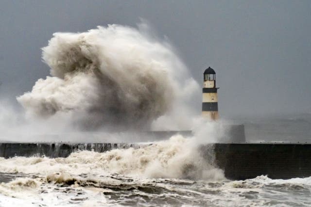 Waves crash against the lighthouse in Seaham Harbour, County Durham (Danny Lawson/PA)