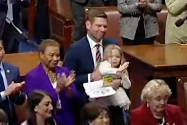 <p>Rep Eric Swalwell and his daughter watch as Nancy Pelosi addresses the House of Representatives</p>