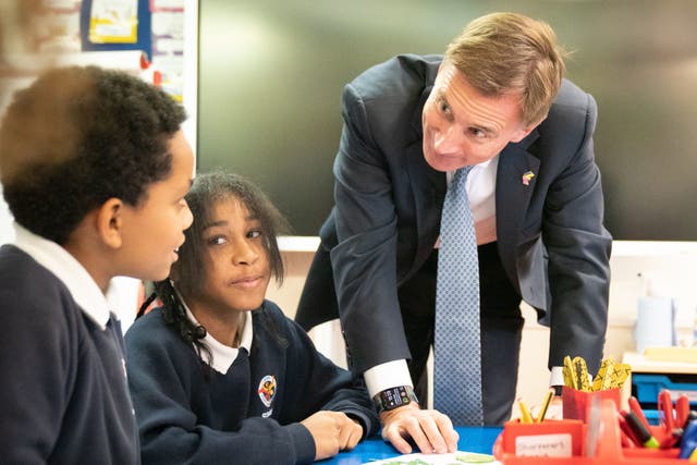 <p>After delivering his autumn statement, Jeremy Hunt met pupils at St Jude’s Church of England Primary School in south London</p>